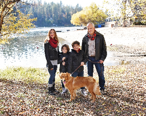 Mona and her family by a lake with their dog
